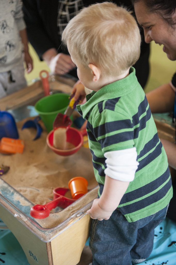 child playing at sand tray