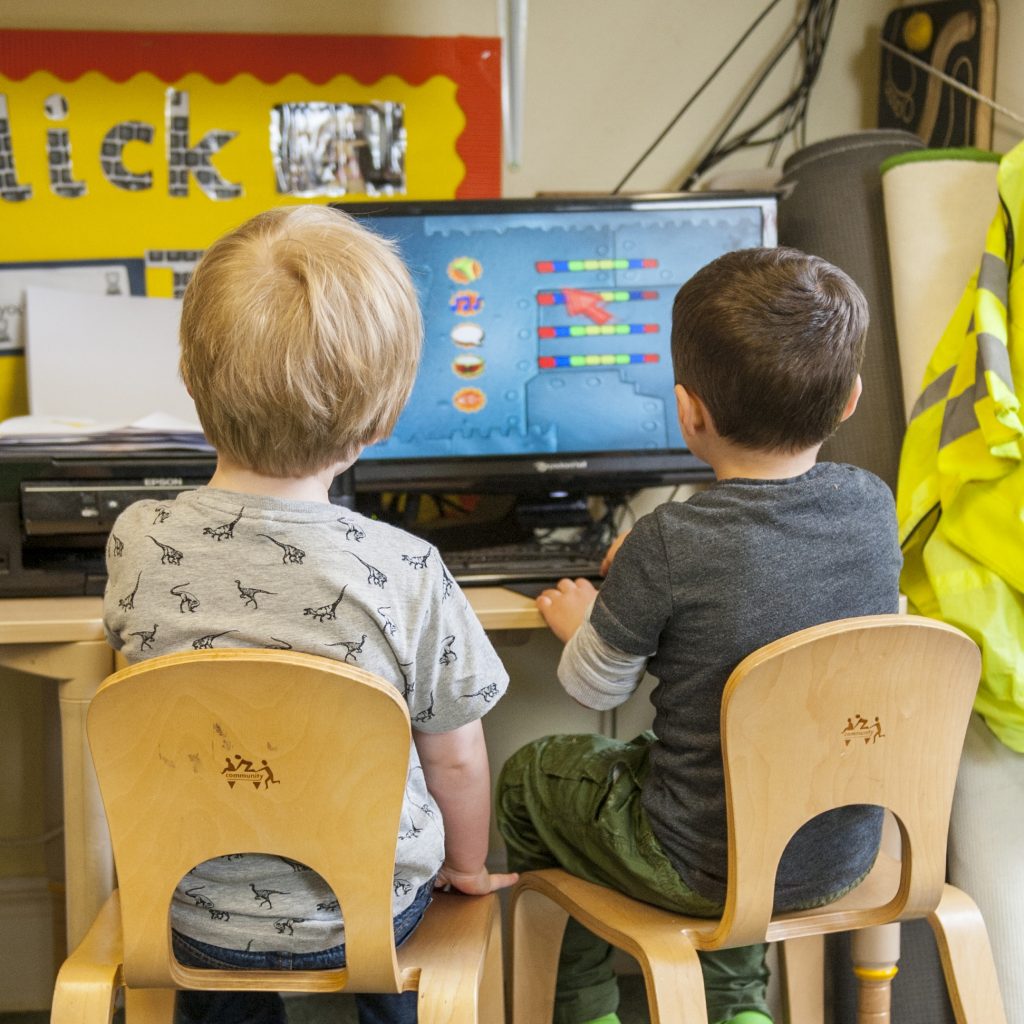 two children at computer desk